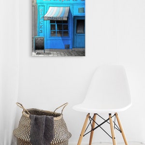 a white chair and a blue store front