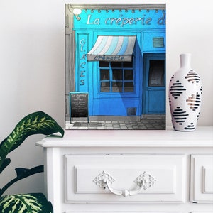 a picture of a blue storefront on a dresser