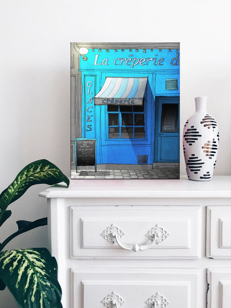 a picture of a blue storefront on a dresser