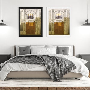 a bedroom with a bed and two pictures on the wall