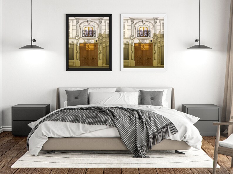 a bedroom with a bed and two pictures on the wall