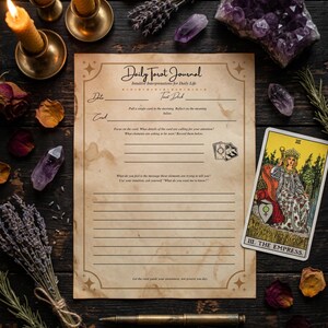 May include: A beige Daily Tarot Journal page with black text, lines for writing, and a small illustration of tarot cards. The page features the title Daily Tarot Journal, Intuitive Interpretations for Daily Life, and the text Let the card guide your awareness, not govern you day.