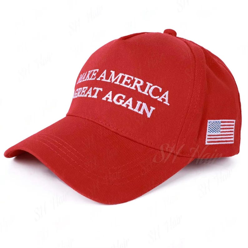 May include: A bright red baseball cap featuring the white embroidered text MAKE AMERICA GREAT AGAIN on the front panel. The side of the cap displays a small, rectangular embroidered patch of the United States flag with red and white stripes.