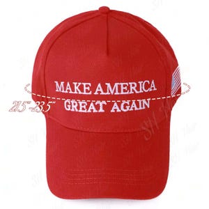 May include: A bright red baseball cap featuring the white embroidered text MAKE AMERICA GREAT AGAIN on the front. A small American flag is embroidered on the side. The cap includes a size indicator showing a range of 21.5 to 23.5 inches.