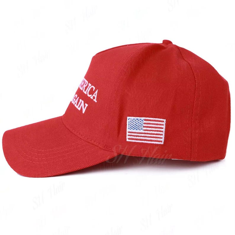 May include: A bright red baseball cap featuring white embroidered text that reads AMERICA AGAIN on the side panel. The cap also includes a small, rectangular embroidered patch of the United States flag in red, white, and blue on the side.