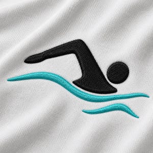 May include: A white fabric featuring an embroidered design of a black swimmer figure positioned above two wavy lines in a vibrant turquoise thread. The embroidery shows a stylised person in a swimming motion with a circular head and angular body.