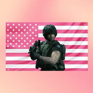 May include: A rectangular wall flag featuring a horizontal pink and white striped pattern with a field of white stars in the upper left corner. A dark-haired character in tactical gear and a black shirt holds a rifle in the center of the flag.