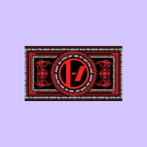 May include: A rectangular black flag featuring a central red circular emblem with a stylized slash and dash symbol. The design includes intricate red border patterns, decorative corner motifs, and repeated text in a gothic font style throughout.