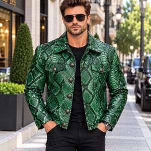 May include: A vibrant green jacket featuring a detailed snakeskin pattern, a classic collar, long sleeves, and a front button closure with metallic buttons. The garment includes two chest pockets with buttoned flaps and a structured, tailored fit.