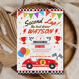 May include: A rectangular birthday invitation card featuring a race car theme with a red car, checkered borders, colorful bunting, trophies, and a speedometer. The text reads Second Lap! the best driver WATSON IS TURNING TWO 5.00 - 7.00 pm 123, Birthday Street Willow Book Drive Sans Desco RSVP Elizy at 123-456-789 by dec 10th.