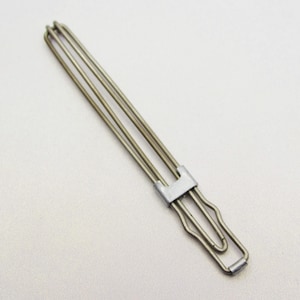 May include: A silver-colored metal hair clip with a unique design. The clip features three parallel wires held together by a rectangular clasp and a curved handle. The clip is designed to hold hair in place.