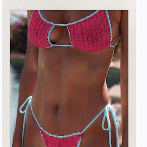 May include: A two-piece crochet bikini set featuring a vibrant magenta color with light blue trim. The top consists of two triangular cups, and the bottom is a tie-side style with adjustable light blue strings on both sides of the hips.