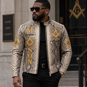 May include: A beige and brown snakeskin-patterned jacket featuring gold embroidered Masonic symbols and the text MASON vertically on the right chest. The jacket includes a stand-up collar, zippered pockets, and gold lettering that reads Your Lodge Name, NO. 1408, and Your Name.