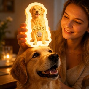 May include: A custom-shaped, illuminated LED night light featuring a printed image of a golden retriever dog. The light emits a warm glow and displays the name Max in cursive script above a small, circular, metallic-colored control button.