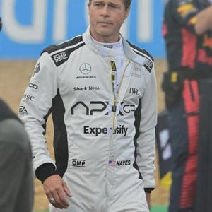 May include: A white and black racing suit featuring the text APXGP, Shark Ninja, IWC, and Expensify on the chest. The suit includes OMP branding, a Mercedes-AMG logo, and a name tag reading HAYES with a small United States flag patch on the front.