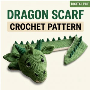 May include: A green crocheted dragon scarf with a detailed head featuring two horns, pointed ears, and black eyes. The scarf body has a row of triangular spikes along the top edge. The text reads: DIGITAL PDF DRAGON SCARF CROCHET PATTERN.
