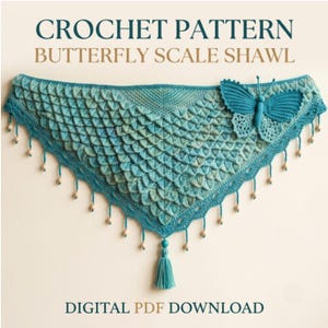 May include: A teal crochet shawl featuring a textured scale pattern, a large three-dimensional butterfly appliqué on the right side, and a bottom edge adorned with small wooden beads and a central tassel. Text reads: CROCHET PATTERN BUTTERFLY SCALE SHAWL DIGITAL PDF DOWNLOAD.