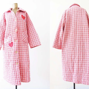 May include: A long red and white gingham robe with a button front and heart-shaped patches.