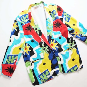 May include: A colorful blazer with a geometric abstract print in shades of red, blue, yellow, green, and black.
