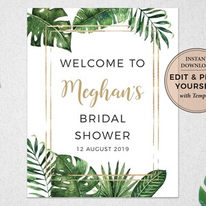 Op de afbeelding: Een wit printbaar bord met een gouden frame en tropische bladeren. De tekst op het bord luidt "Welkom bij Meghans Bridal Shower 12 augustus 2019".
