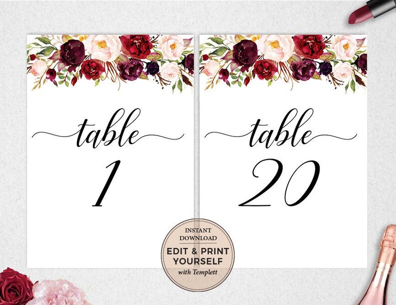 May include: Two white table number cards with burgundy floral designs. The text "table" is written in a script font with the numbers "1" and "20" below. The text "Instant Download Edit & Print Yourself with Templett" is printed on a circle in the bottom right corner of the card.
