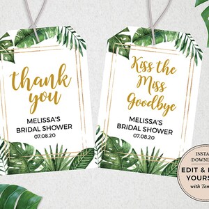 Op de afbeelding: Twee printbare bruiloft-favorietenlabels met een tropisch thema. De labels hebben een gouden frame met groene aquarelbladeren en de tekst "dankjewel" en "Kiss the Miss Goodbye".