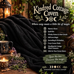 May include: A black textured throw blanket next to a mug with gold forest and moon graphics, a lit candle, and a mushroom figurine. Text reads: Kindred Cottage Coven, Where cozy meets a little bit of magic, Mystery Boxes, Spell Kits, and more.
