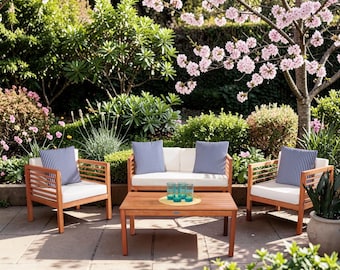 May include: A patio furniture set consisting of two armchairs, a loveseat, and a rectangular coffee table, all crafted from light brown wood. The chairs and loveseat feature white seat cushions and navy blue and white striped throw pillows.