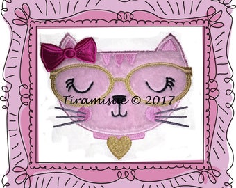 May include: Pink cat with a pink bow, gold-rimmed glasses, and a gold heart on its chest. The cat has its eyes closed and a small smile. The text "Tiramisu © 2017" is below the cat.