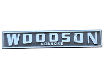 Woodson Roanoke Emblem Vintage Cast Metal Nameplate Sign Black Silver Good