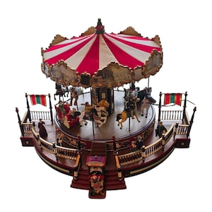 May include: A miniature carousel featuring a red and white striped canopy, a central rotating platform with various animal figures and riders, and a ticket booth at the base. The structure includes ornate gold-toned trim, railings, and small figurines.