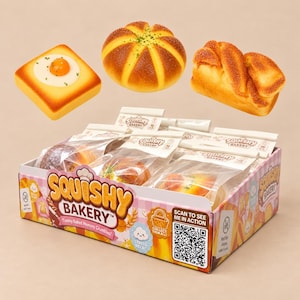 May include: A Squishy Bakery display box containing individually wrapped foam bread toys, including a square toast with a fried egg, a round bun, and a braided loaf. The box features the text Squishy Bakery, Yummy Baked Memory Crumbles, and a QR code.
