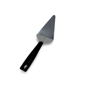May include: A cake server featuring a triangular, polished stainless steel blade attached to a black, textured plastic handle. The handle includes a small, circular hole at the end for hanging, and the blade is secured to the handle with two rivets.