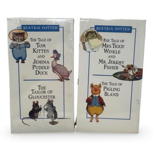 May include: Two shrink-wrapped Beatrix Potter book sets featuring illustrations of Tom Kitten, Jemima Puddle-Duck, The Tailor of Gloucester, Mrs. Tiggy-Winkle, Mr. Jeremy Fisher, and Pigling Bland with their respective titles printed in black text.