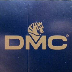 May include: A blue background with a gold logo of a horse's head and the text "DMC" in gold.