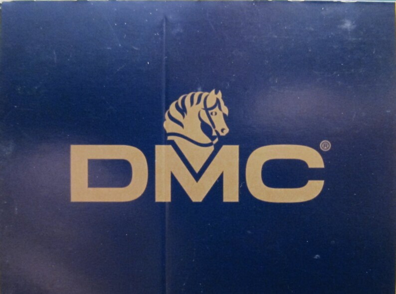 May include: A blue background with a gold logo of a horse's head and the text "DMC" in gold.