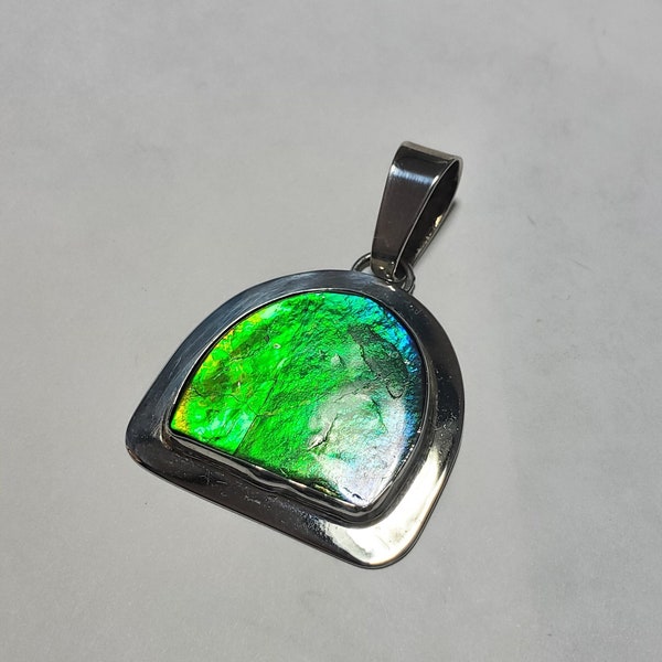 Ammolite pendant  Light green ammolite from Canada. Classified as the  Rarest gemstone on earth.  It is 70 million years old.  A rate piece.