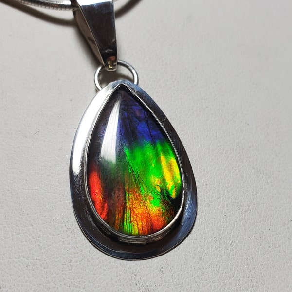 Ammolite pendant.  perfect and beautiful ammolite.  Classified as the rarest gemstone. Colors Red blue yellow green  Ammolite necklace.