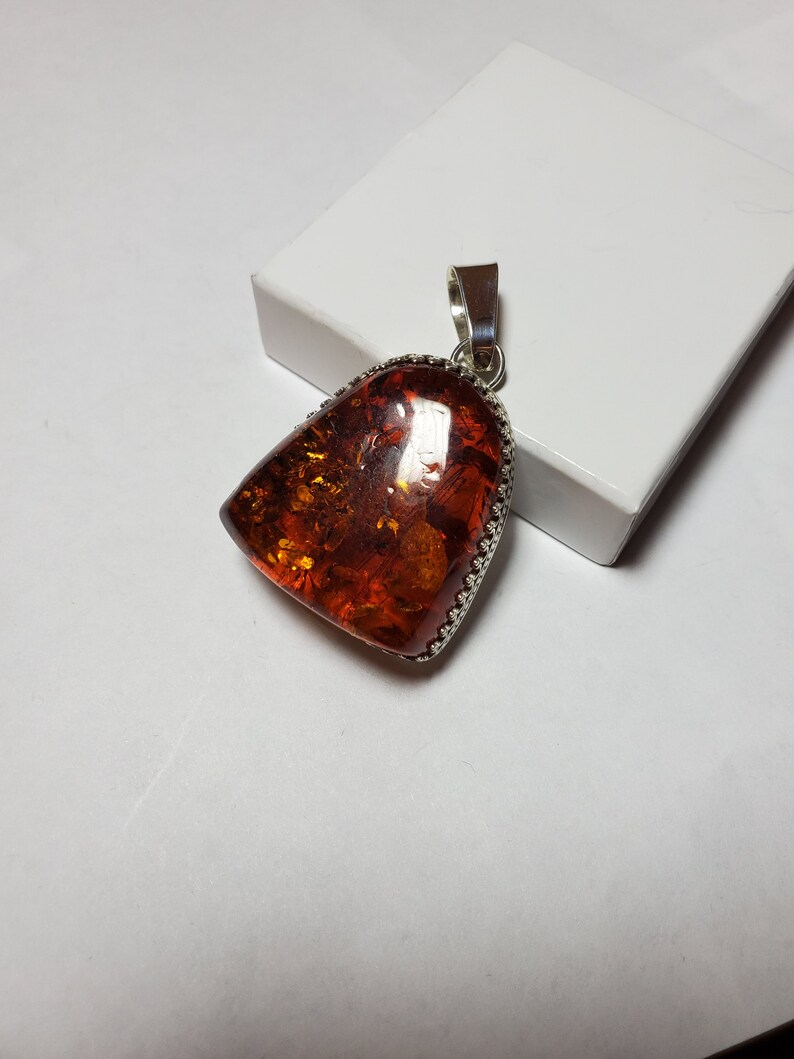 Baltic amber pendant with silver gallery wire bezel. Amber pendant