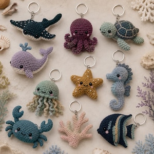 May include: A collection of ten crocheted marine animal keychains including a dark blue stingray, purple octopus, green sea turtle, lavender whale, light green jellyfish, golden starfish, blue seahorse, blue crab, pink coral, and a striped fish.