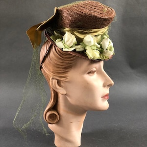 Fabulous Forties Light Brown Woven Straw Tilt Topper Hat with White Flowers, Green-Gold Ribbon and Green Netting OSFM