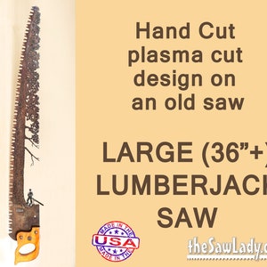 May include: A large, rusty saw blade with a plasma cut design of a tree. The saw blade is over 36 inches long and has a wooden handle. The saw blade is labeled "LARGE (36" +) LUMBERJACK SAW" and "the SawLady.com". A red, white, and blue "MADE IN THE USA" sticker is on the saw blade.
