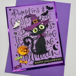 May include: A purple Halloween greeting card featuring a black cat wearing a purple witch hat and bow tie. The card displays text including Pumpkins, Ghosts, Bats, and Happy Halloween. It is decorated with a small ghost, bats, a pumpkin bucket, and colorful candy accents on a purple envelope.