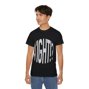 May include: A black short-sleeve t-shirt featuring a large, circular graphic on the chest. The graphic contains the text A'IGHT!? in bold, light gray, vertical sans-serif lettering that fills the circular shape against the black fabric.