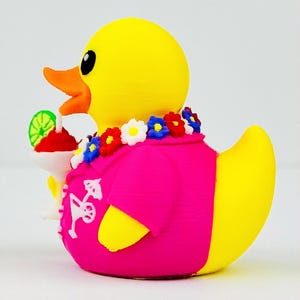 May include: A yellow rubber duck wearing a bright pink shirt with a white cocktail print, a colorful floral lei around its neck, and holding a small white cocktail glass with a red drink and a green lime slice garnish in its orange beak.