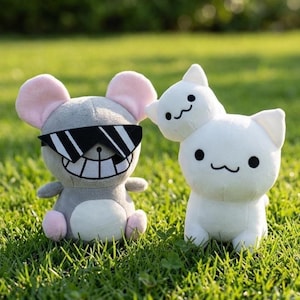 May include: A gray plush mouse with pink inner ears, wearing black and white shutter-style sunglasses and a wide, toothy grin, standing next to a white plush cat with a smaller white cat head attached to its top and a simple black mouth.