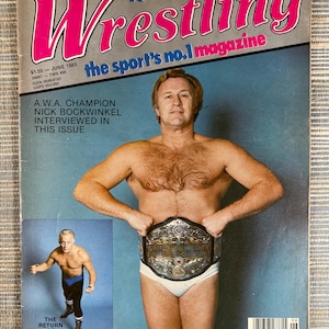 May include: A vintage magazine cover for "The Ring's Wrestling" from June 1983. The cover features a shirtless man holding a championship belt. The magazine title is in pink and white, with the text "the sport's no.1 magazine". A smaller image shows another wrestler.