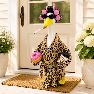 May include: A white goose figurine wearing a leopard print bathrobe, black sunglasses, and pink hair rollers. The goose holds a pink frosted donut and a coffee cup, wears a gold chain necklace, and has a cigarette in its yellow beak.