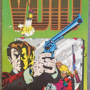 May include: A comic book titled View From The Void with a green cover featuring a man in a dark suit holding a blue revolver. A shattered lightbulb hangs from a chain above. The background shows a mirror reflecting a scene with a rifle and figures.