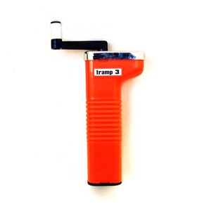 May include: An orange hand-cranked tool with a black handle and a white crank. The tool has a rectangular body with the text "tramp 3" on it. The handle is black and the crank is white.